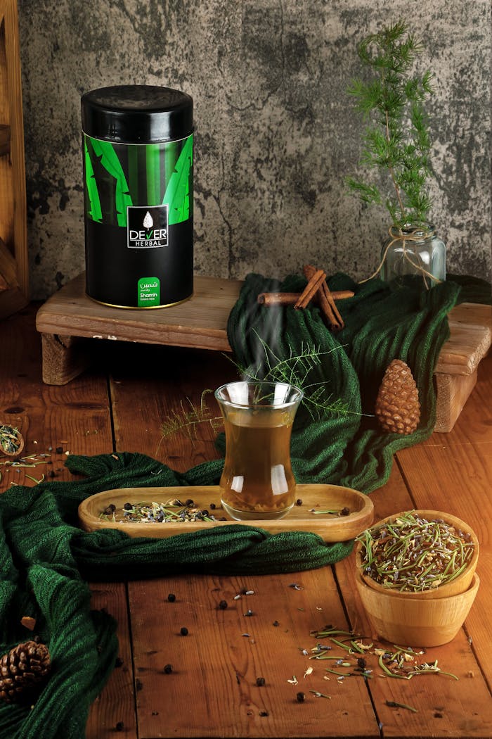A cozy arrangement showcasing herbal tea with natural spices on a rustic wooden background.